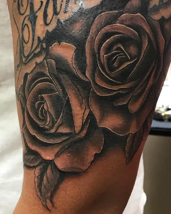 roses black and grey tattoo arm